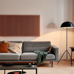 **A cozy living room in Sweden, featuring sound-absorbing panels designed as minimalist art. Gentle, ambient lighting enhances the calming atmosphere. Include subtle elements like a vintage record player and a collection of vinyl records, suggesting a curated soundscape.**